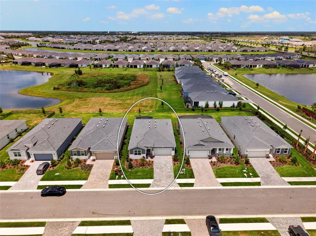 18237 Beach Ranch Terrace Bradenton, FL 34211 - Photo 11 of 72 an aerial view of residential houses with outdoor space and ocean view