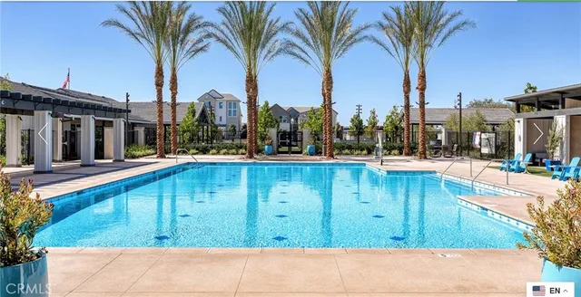 a backyard of a house with lots of green space and a fountain