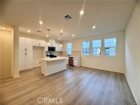 a kitchen with stainless steel appliances a sink dishwasher stove and microwave