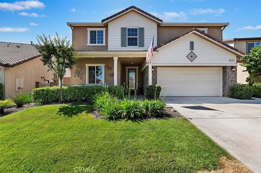 11745 Silver Birch Road Corona, CA 92883 - Photo 4 of 62 a front view of a house with a yard and garage