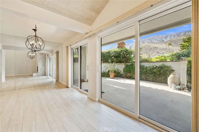 a view of a room with wooden floor and door
