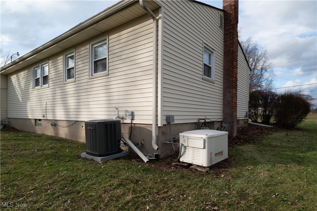 376 Johnson Plank Road Warren, OH 44481 - Photo 24 of 28 View of side of home featuring a lawn, a chimney, and whole house generator.