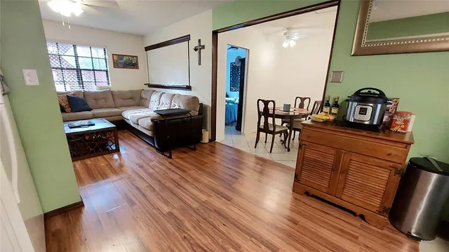 a living room with furniture and a wooden floor