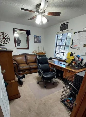 a living room with furniture a air conditioner and a window