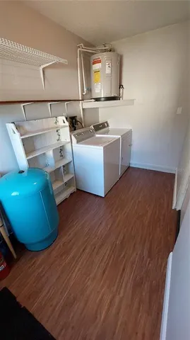 a room with wooden floor and furniture