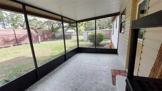 a view of an empty room with large windows