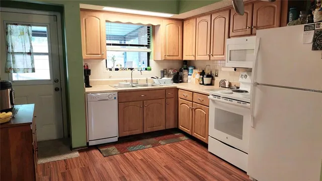 a kitchen with white cabinets sink and white appliances