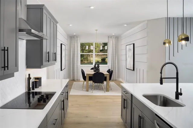 a kitchen with a stove a sink and a refrigerator