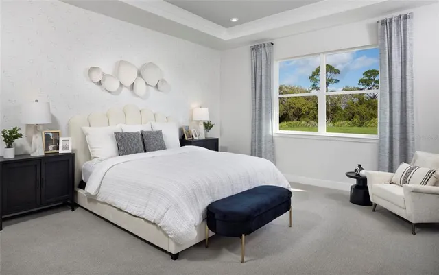 a bedroom with a bed and a painting on the wall