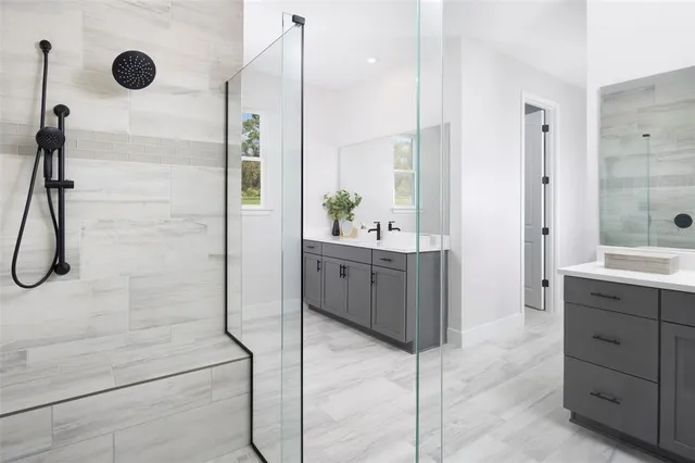 a bathroom with a double vanity sink a mirror and shower