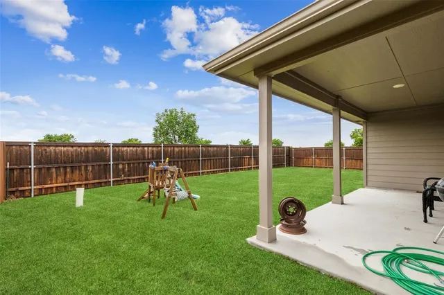 a view of a backyard with sitting area