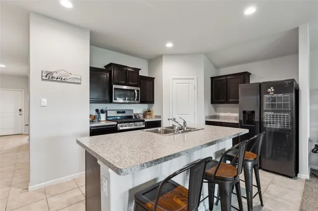 a kitchen with a stove a sink and a refrigerator