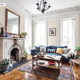 a living room with furniture large window and a fireplace