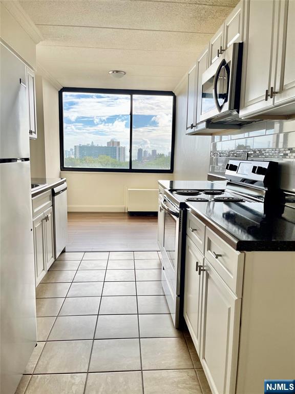 464 Gorge Road, Unit 5H Cliffside Park, NJ 07010 - Photo 3 of 7 a kitchen with stainless steel appliances a stove a sink and a refrigerator