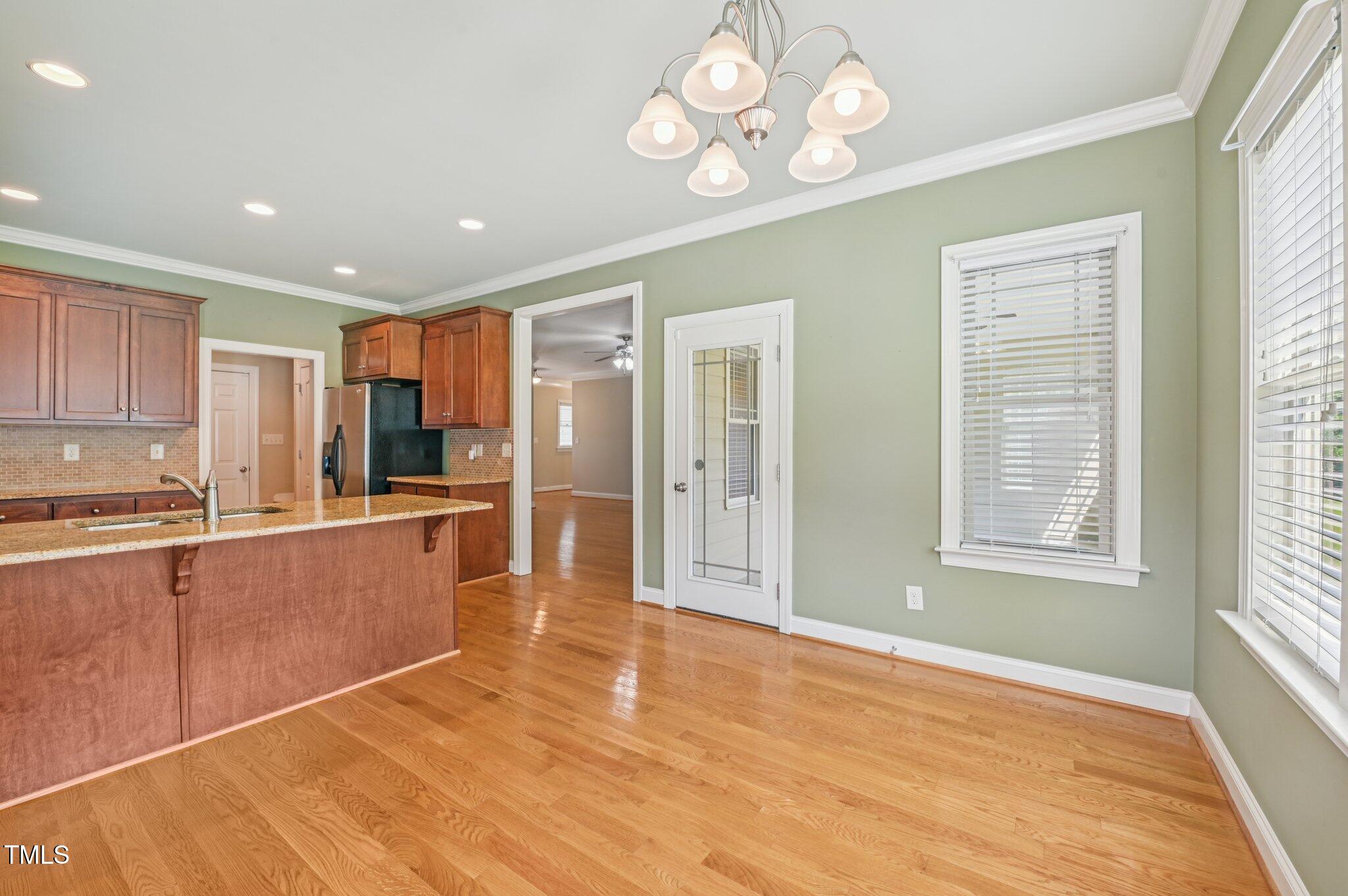 75 Crestline Drive Selma, NC 27576 - Photo 11 of 31 a view of a kitchen with a stove cabinets wooden floor and a kitchen