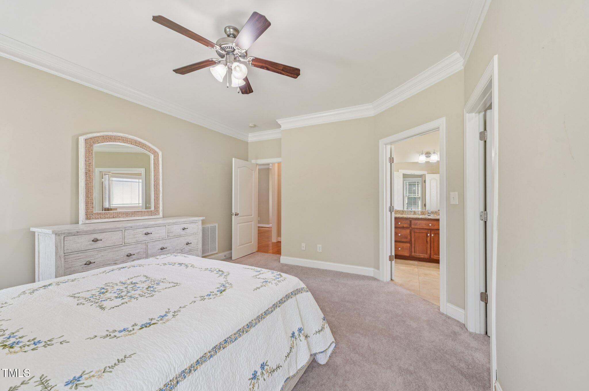 75 Crestline Drive Selma, NC 27576 - Photo 14 of 31 a spacious bedroom with a bed and a chandelier