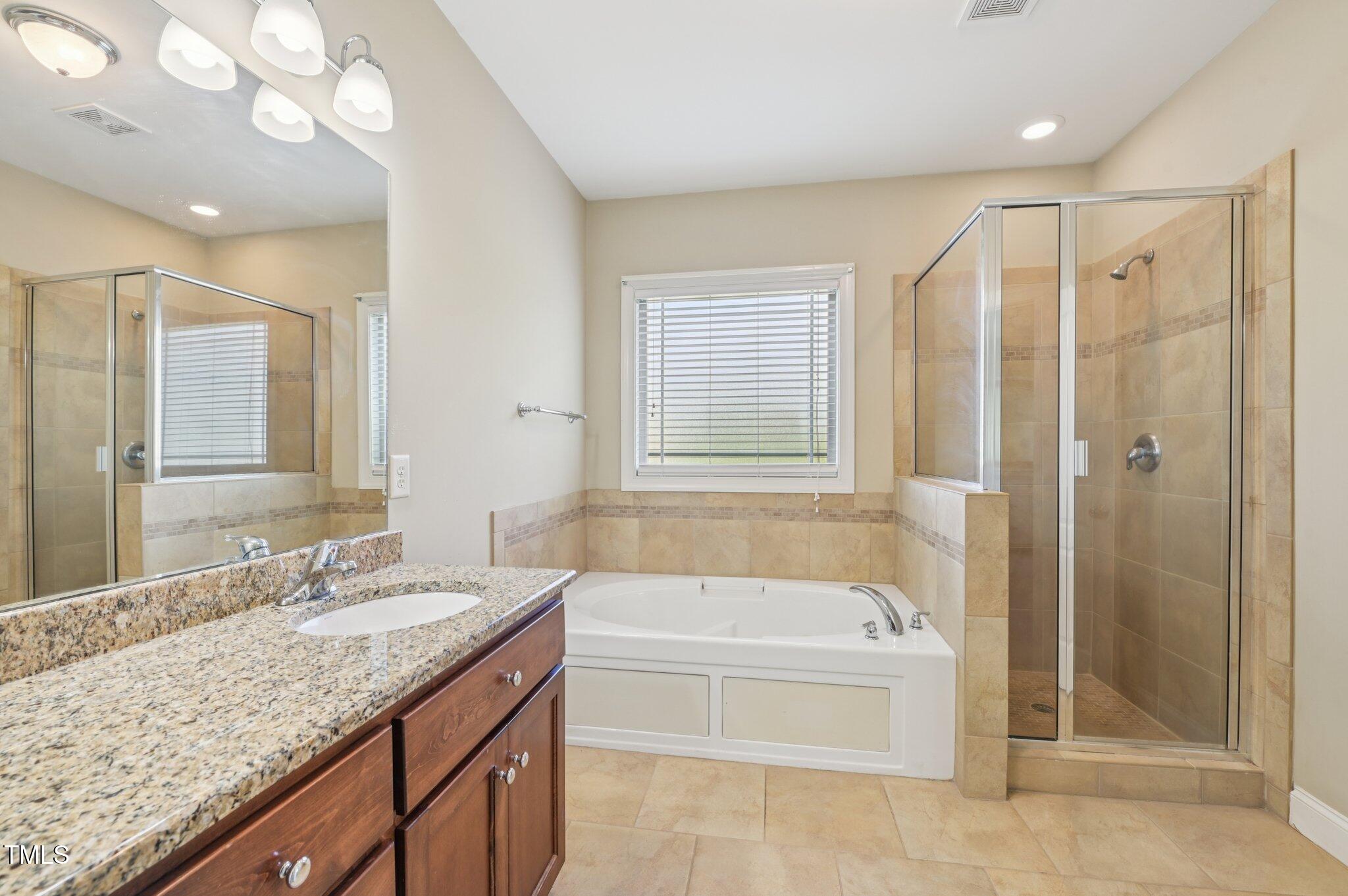75 Crestline Drive Selma, NC 27576 - Photo 16 of 31 a bathroom with a granite countertop tub sink shower and mirror