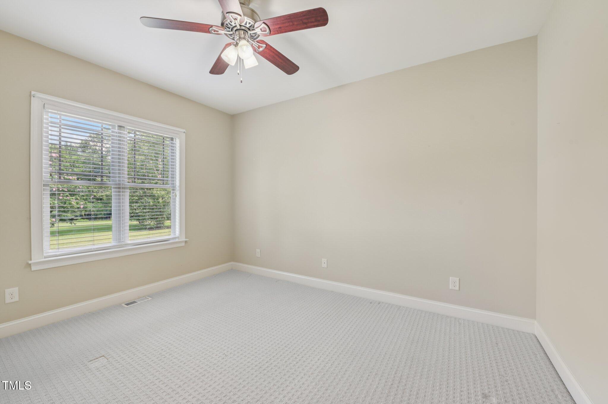 75 Crestline Drive Selma, NC 27576 - Photo 18 of 31 an empty room with a window and a fan