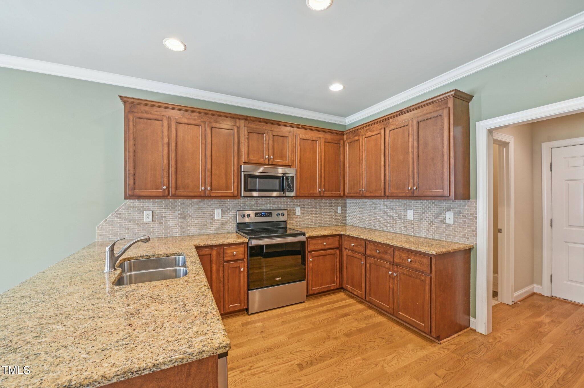 75 Crestline Drive Selma, NC 27576 - Photo 8 of 31 a kitchen with stainless steel appliances granite countertop a stove a sink and a microwave