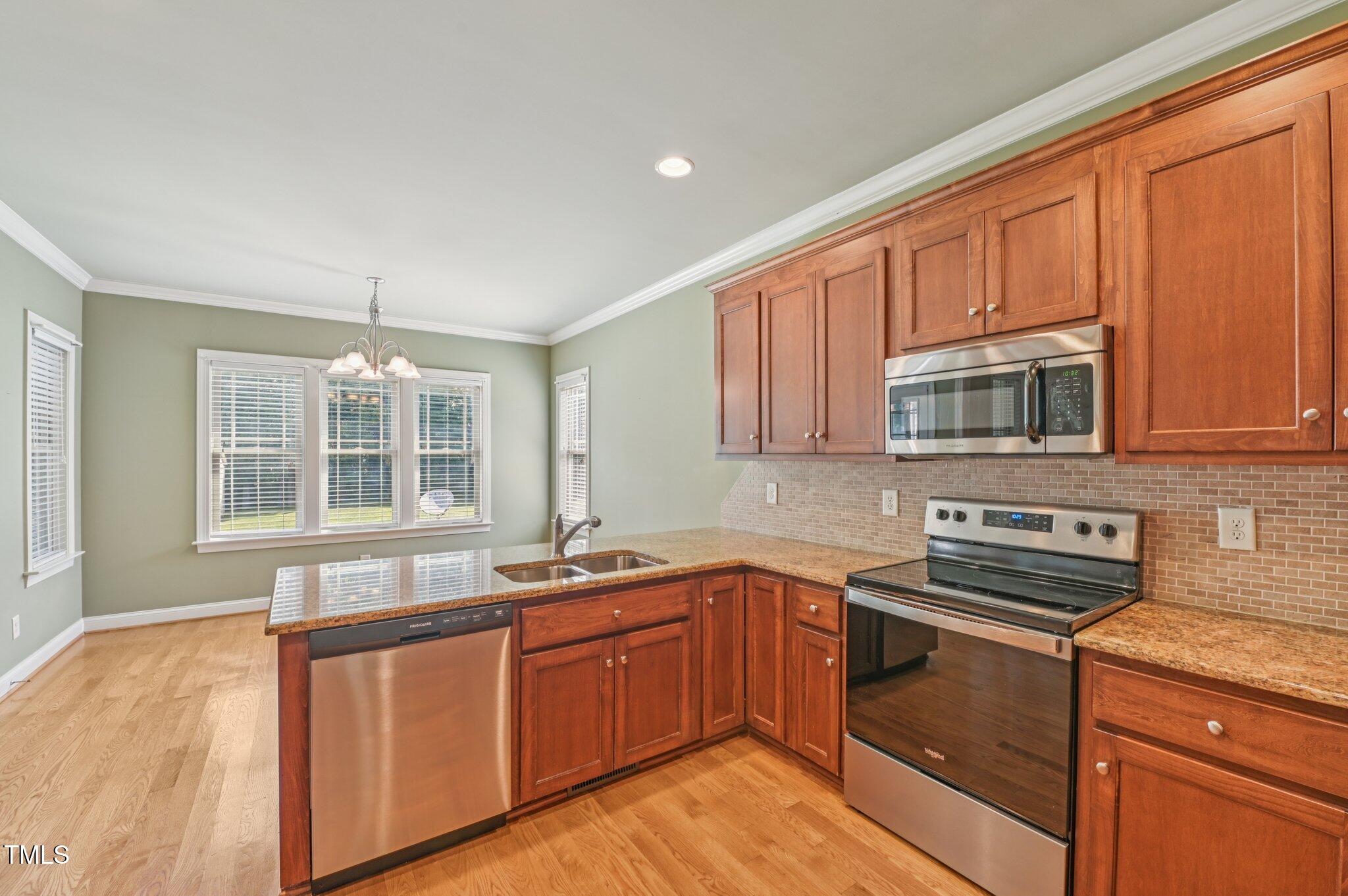 75 Crestline Drive Selma, NC 27576 - Photo 10 of 31 a kitchen with stainless steel appliances granite countertop a sink stove and microwave