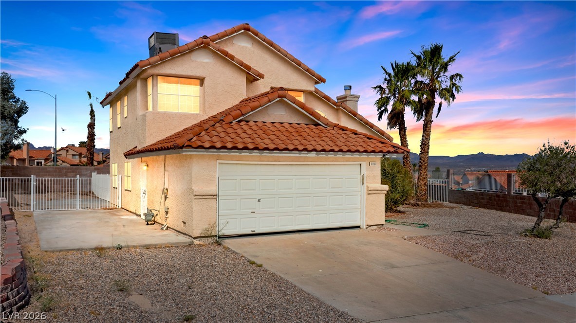 3156 Terrace View Drive Laughlin, NV 89029 - Photo 2 of 94 A terracotta-tiled roof crowns this residence, featuring an attached garage and commanding mountain views.