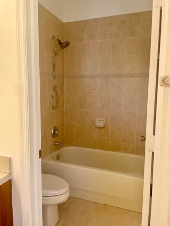 a bathroom with a shower a bathtub and toilet