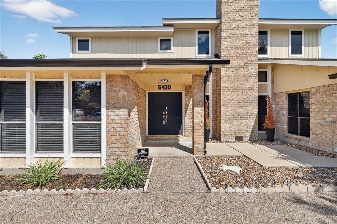 5410 Fox Run Drive Corpus Christi, TX 78413 - Photo 2 of 40 a front view of a house with a yard and garage