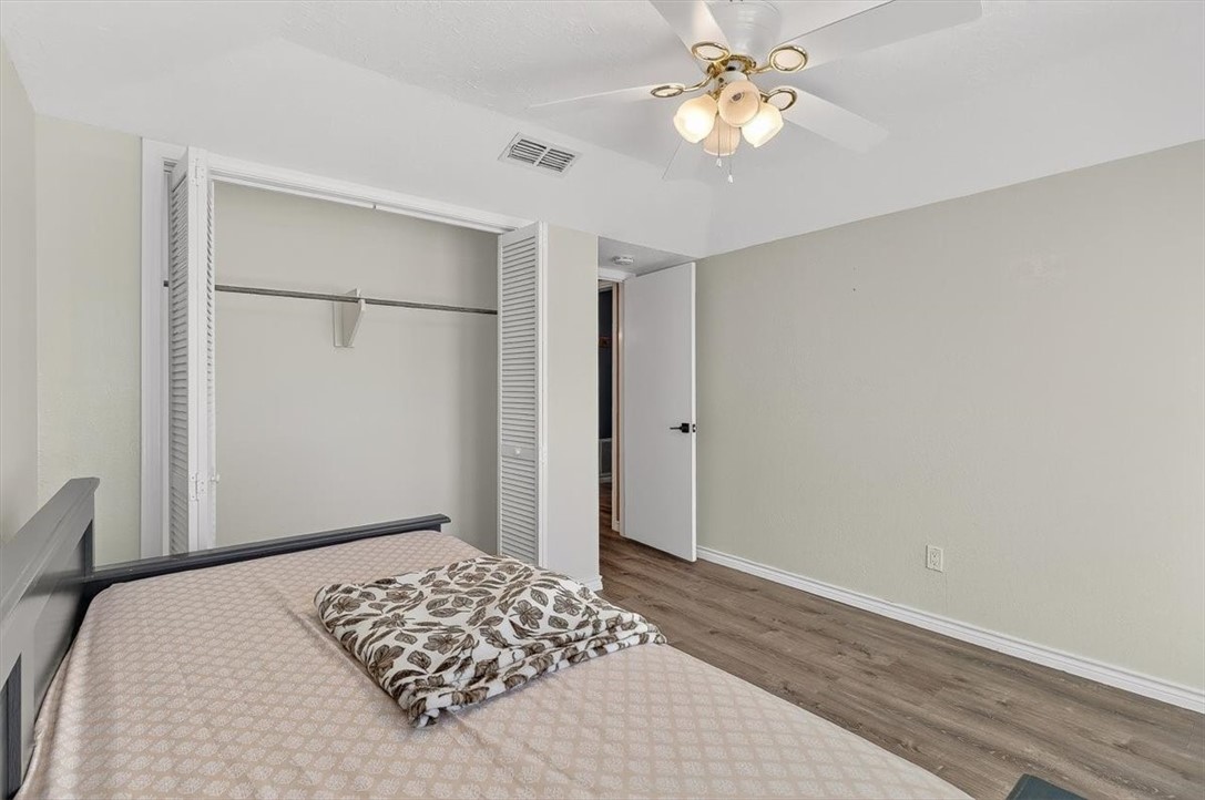 5410 Fox Run Drive Corpus Christi, TX 78413 - Photo 26 of 40 a bedroom with a bed and a chandelier