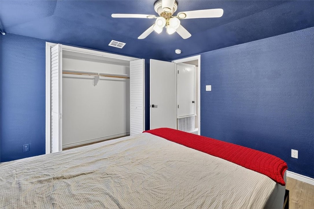 5410 Fox Run Drive Corpus Christi, TX 78413 - Photo 31 of 40 a bedroom with a bed and a chandelier