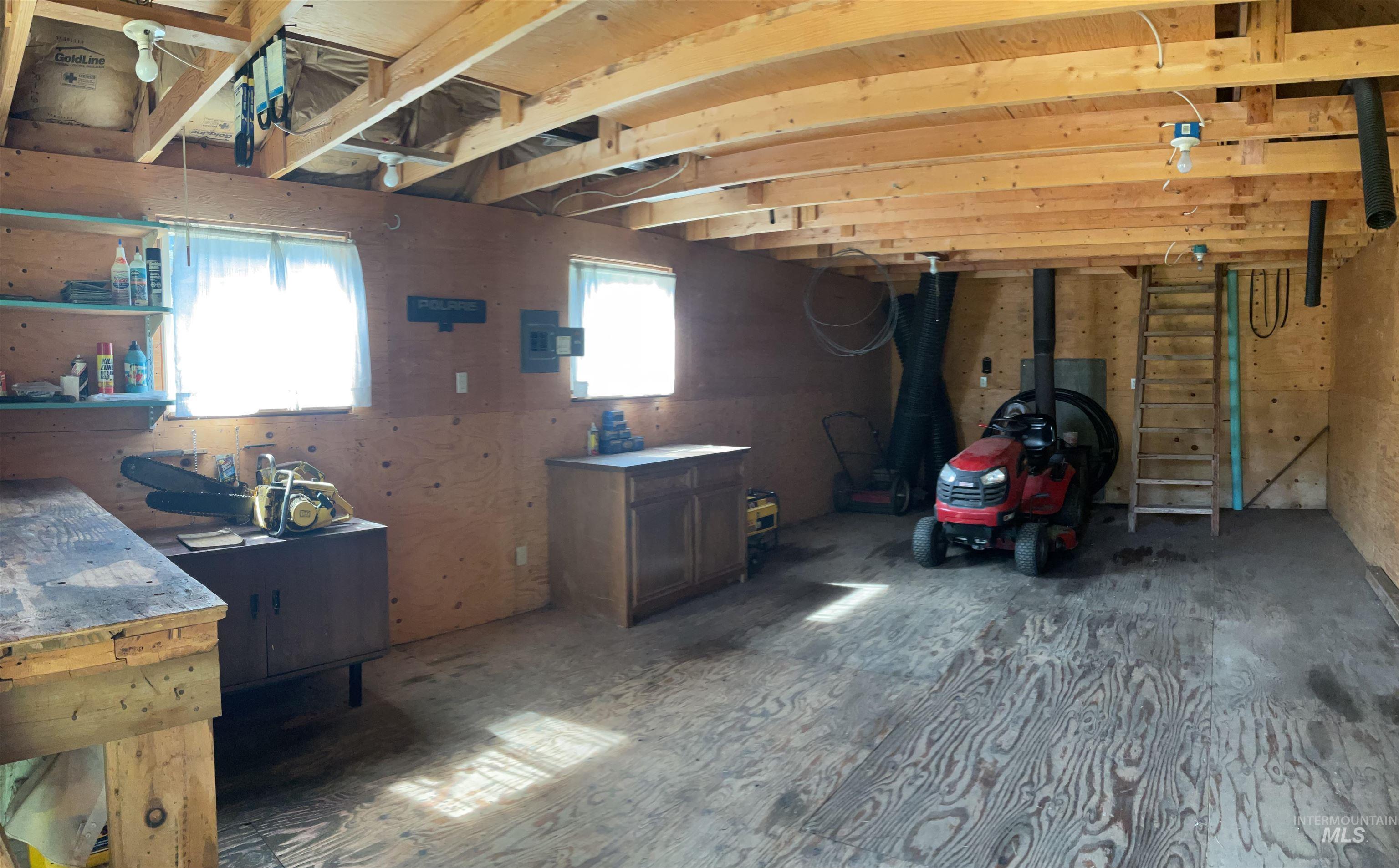 2871 Orogrande-Dixie Road Elk City, ID 83525 - Photo 12 of 40 Utility space featuring exposed wood beam ceiling, raw plywood walls, and a wood-finish floor