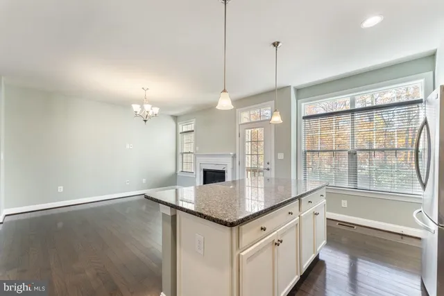 a kitchen with stainless steel appliances granite countertop a sink a stove and a refrigerator