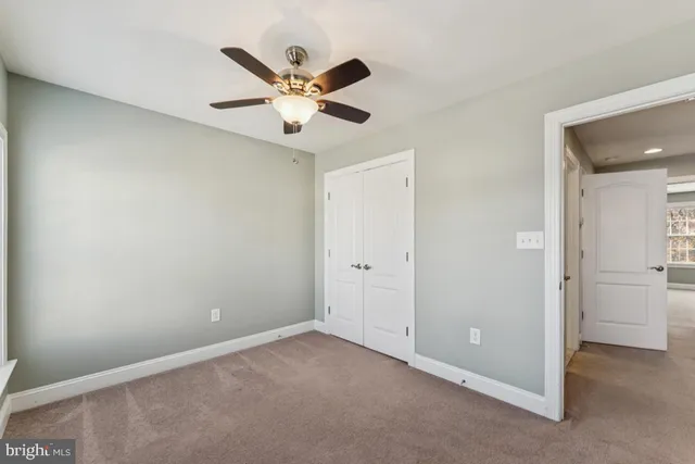 an empty room with a ceiling fan