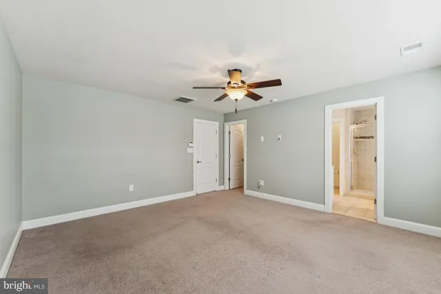 a view of a room with a window and a fan