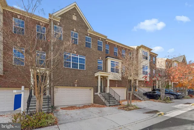 a front view of a building with a yard