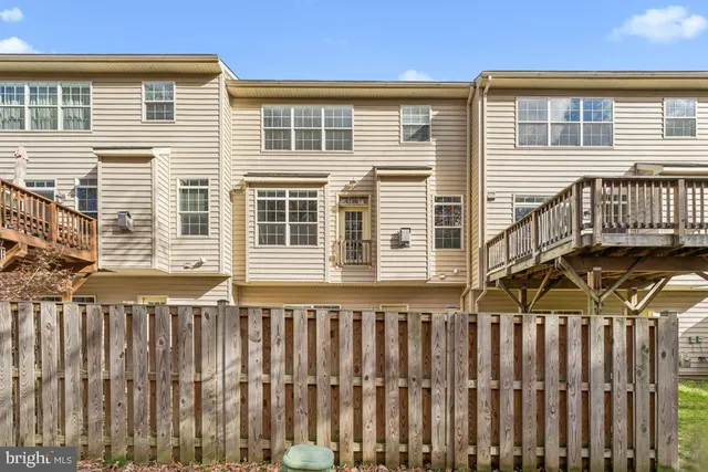 a view of a house with wooden fence