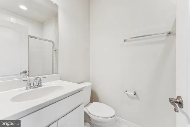 a bathroom with a sink toilet and a mirror