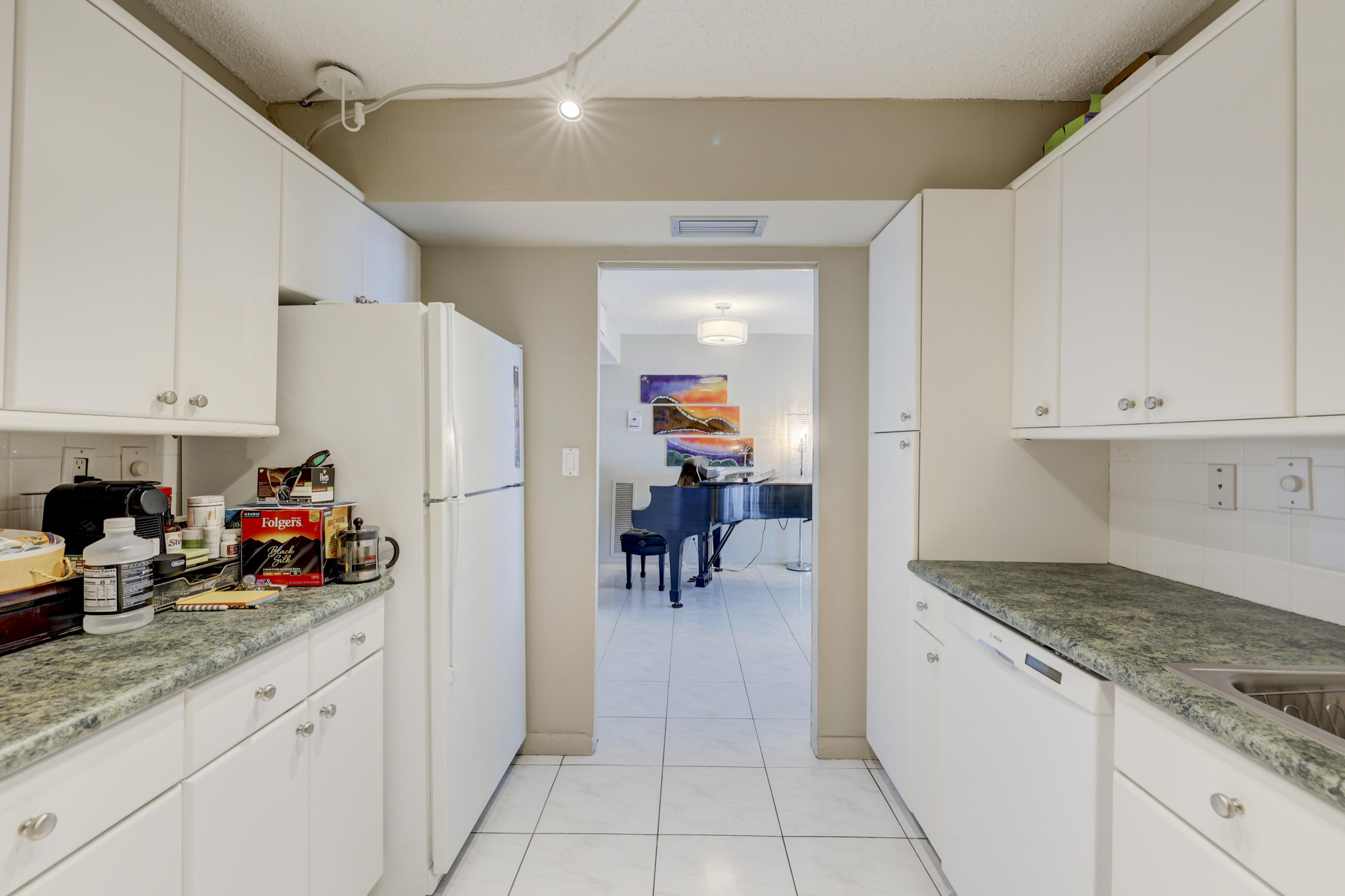 531 North Ocean Boulevard, Unit 710 Pompano Beach, FL 33062 - Photo 16 of 39 a kitchen with stainless steel appliances granite countertop a refrigerator and a stove