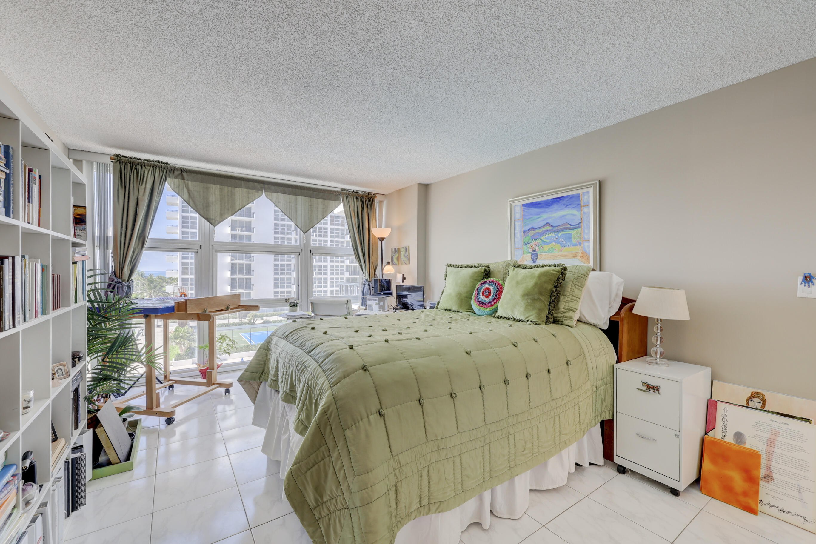 531 North Ocean Boulevard, Unit 710 Pompano Beach, FL 33062 - Photo 17 of 39 a bed sitting in a bedroom next to a window