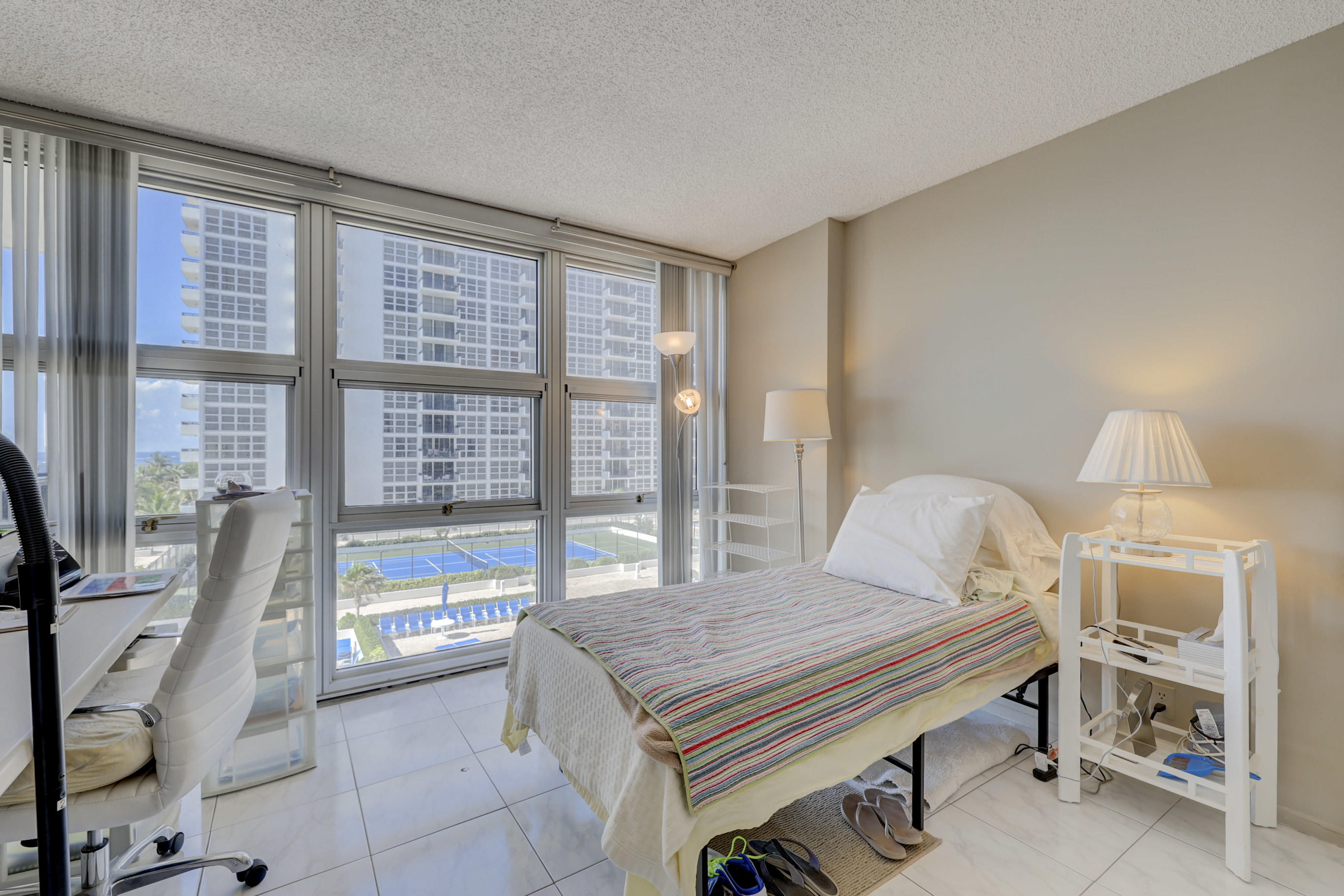 531 North Ocean Boulevard, Unit 710 Pompano Beach, FL 33062 - Photo 22 of 39 a bedroom with a bed and large window