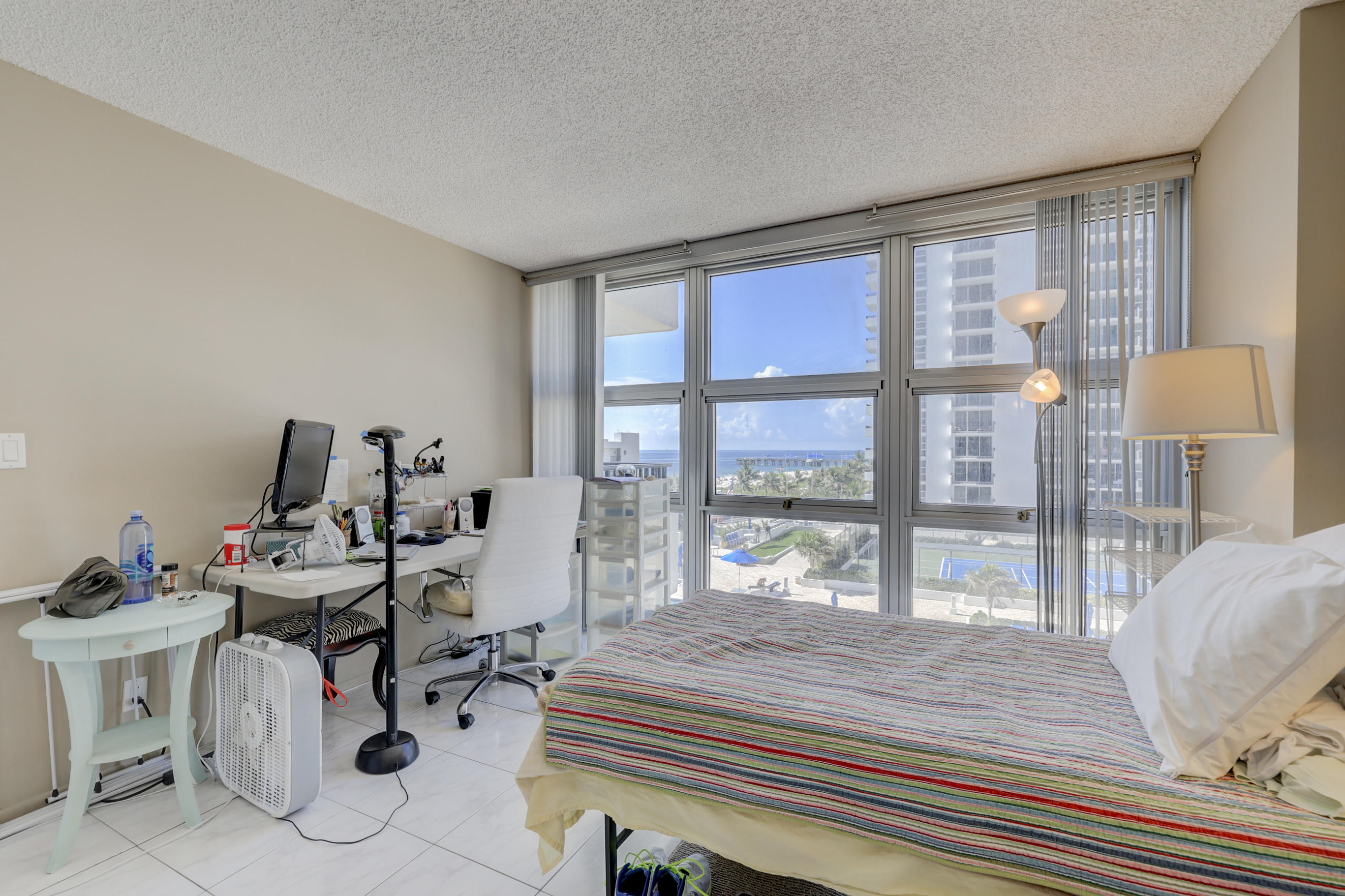 531 North Ocean Boulevard, Unit 710 Pompano Beach, FL 33062 - Photo 23 of 39 a bedroom with furniture and a large window