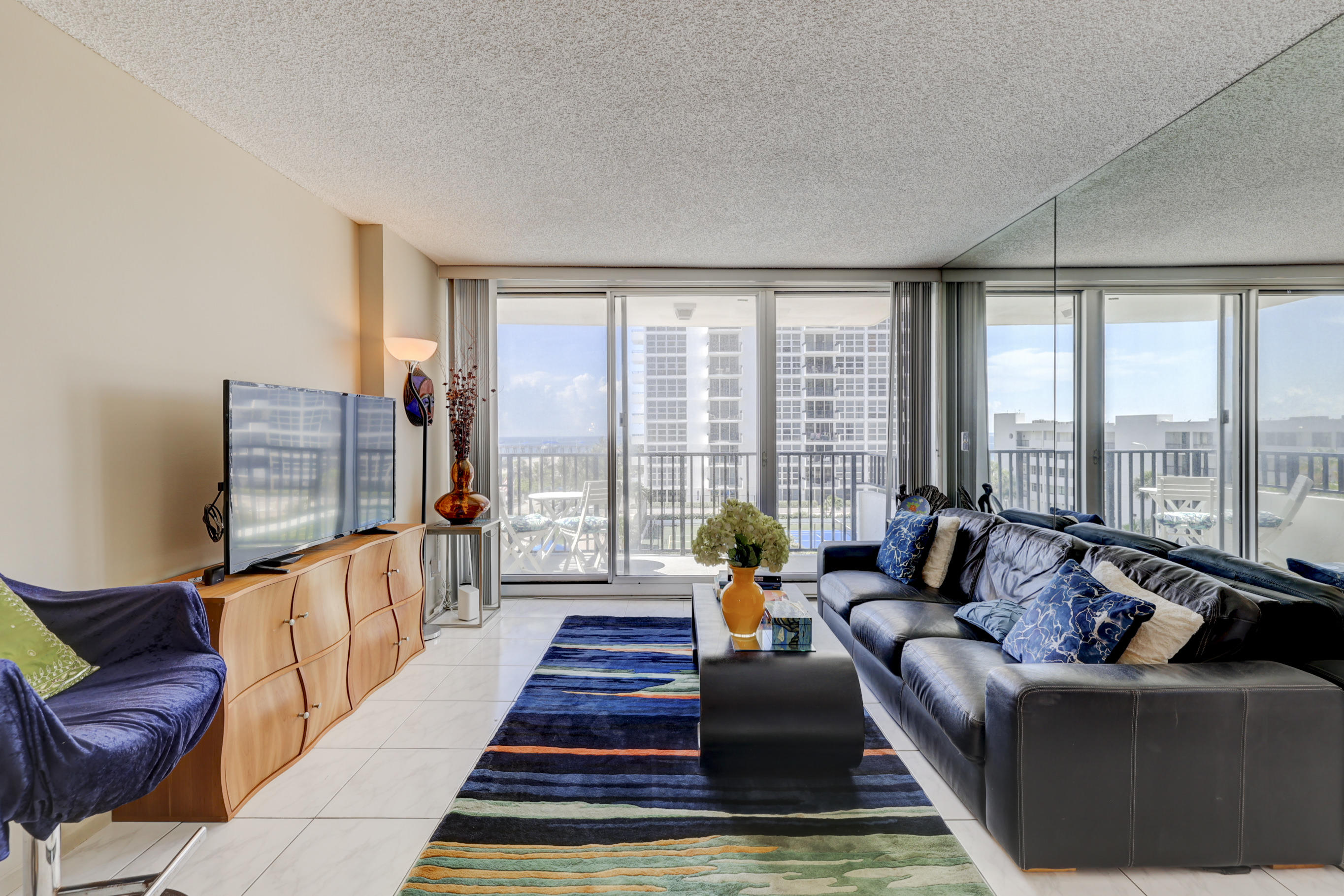 531 North Ocean Boulevard, Unit 710 Pompano Beach, FL 33062 - Photo 6 of 39 a living room with furniture and a rug
