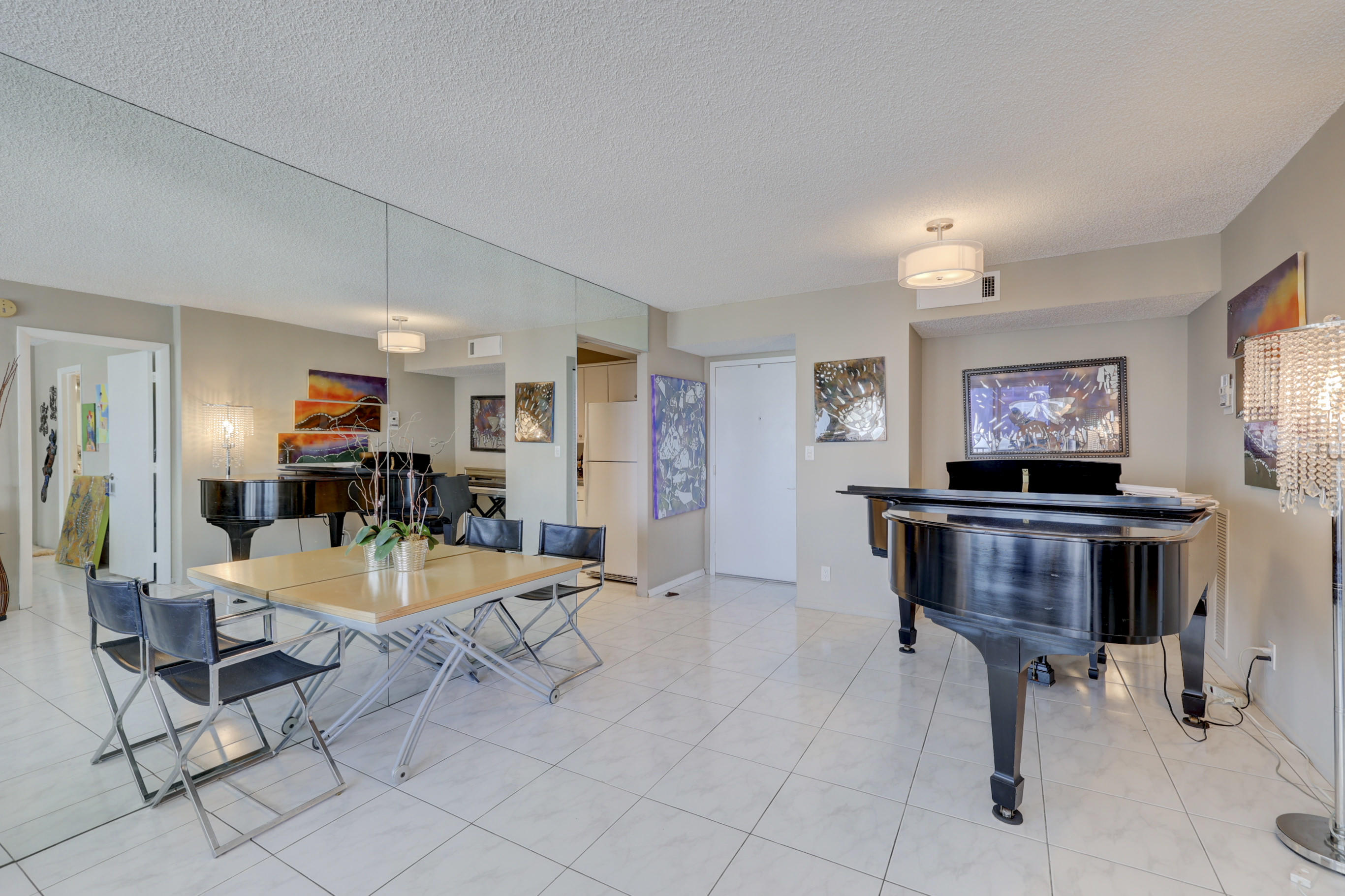 531 North Ocean Boulevard, Unit 710 Pompano Beach, FL 33062 - Photo 7 of 39 a living room with furniture and a flat screen tv