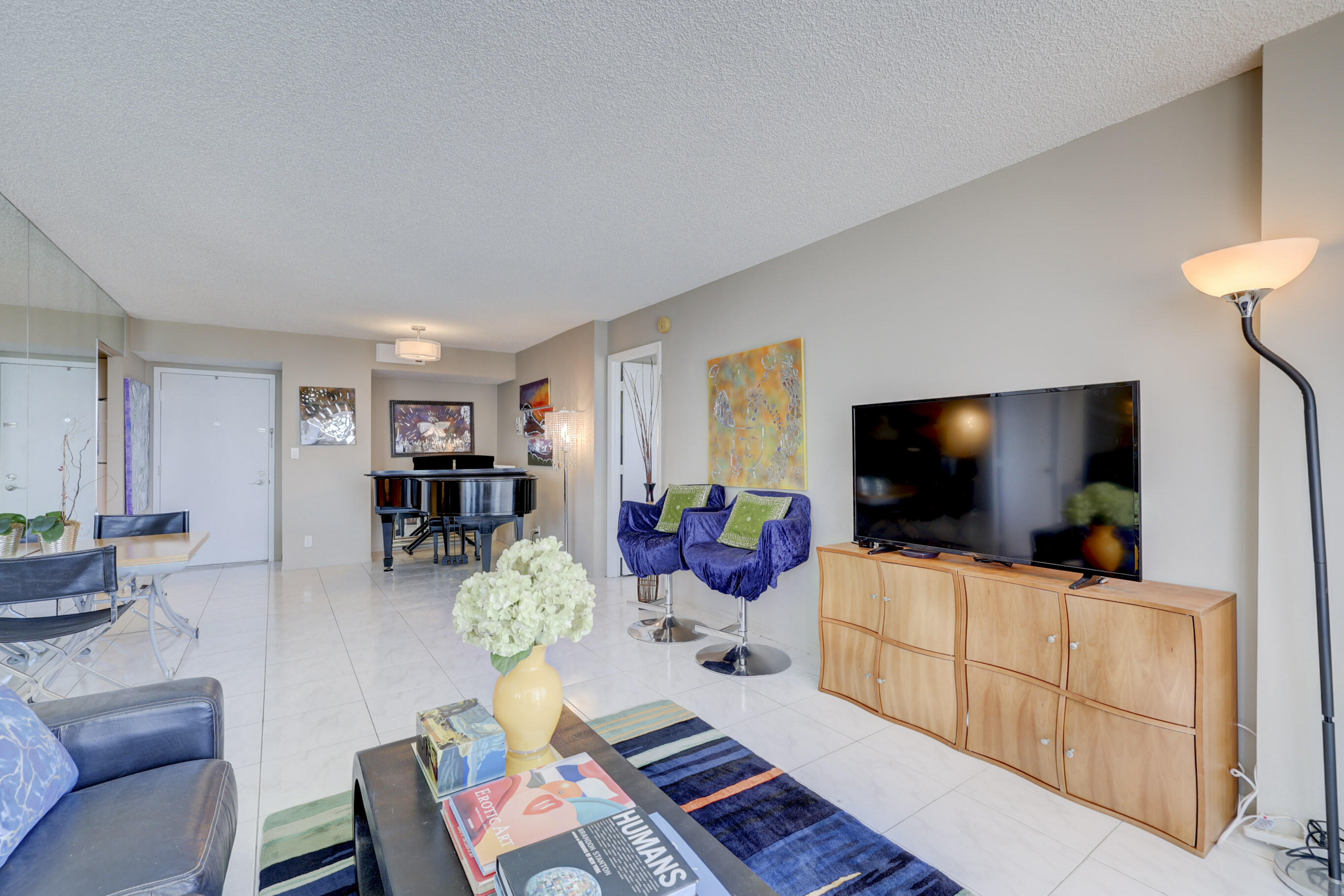 531 North Ocean Boulevard, Unit 710 Pompano Beach, FL 33062 - Photo 9 of 39 a living room with furniture and a flat screen tv