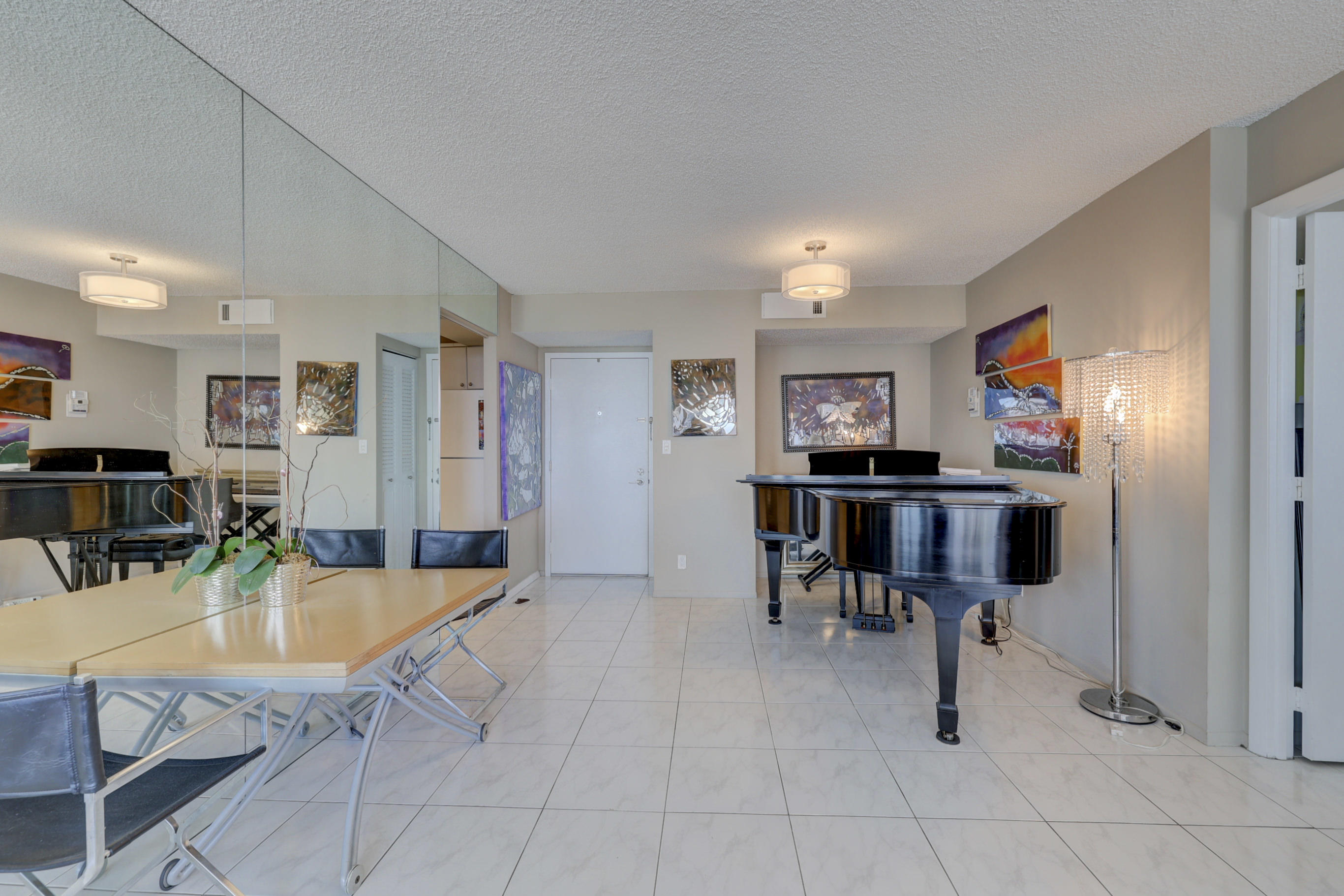 531 North Ocean Boulevard, Unit 710 Pompano Beach, FL 33062 - Photo 10 of 39 a view of kitchen with sink refrigerator dining table and chairs