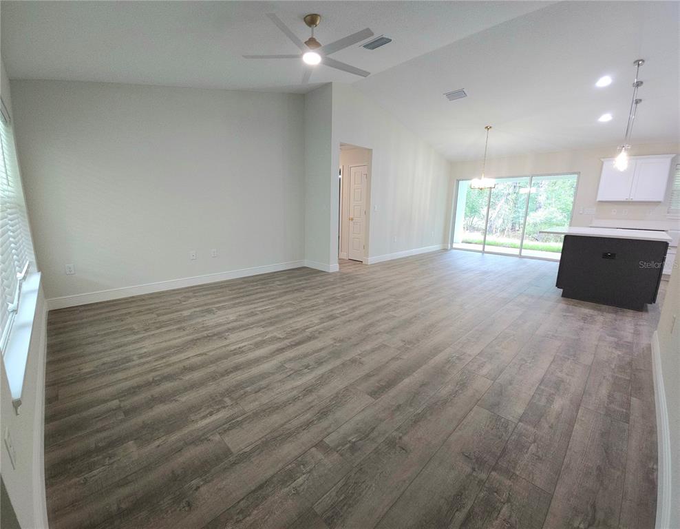 9547 North Sandree Drive Citrus Springs, FL 34434 - Photo 12 of 14 an empty room with wooden floor and windows