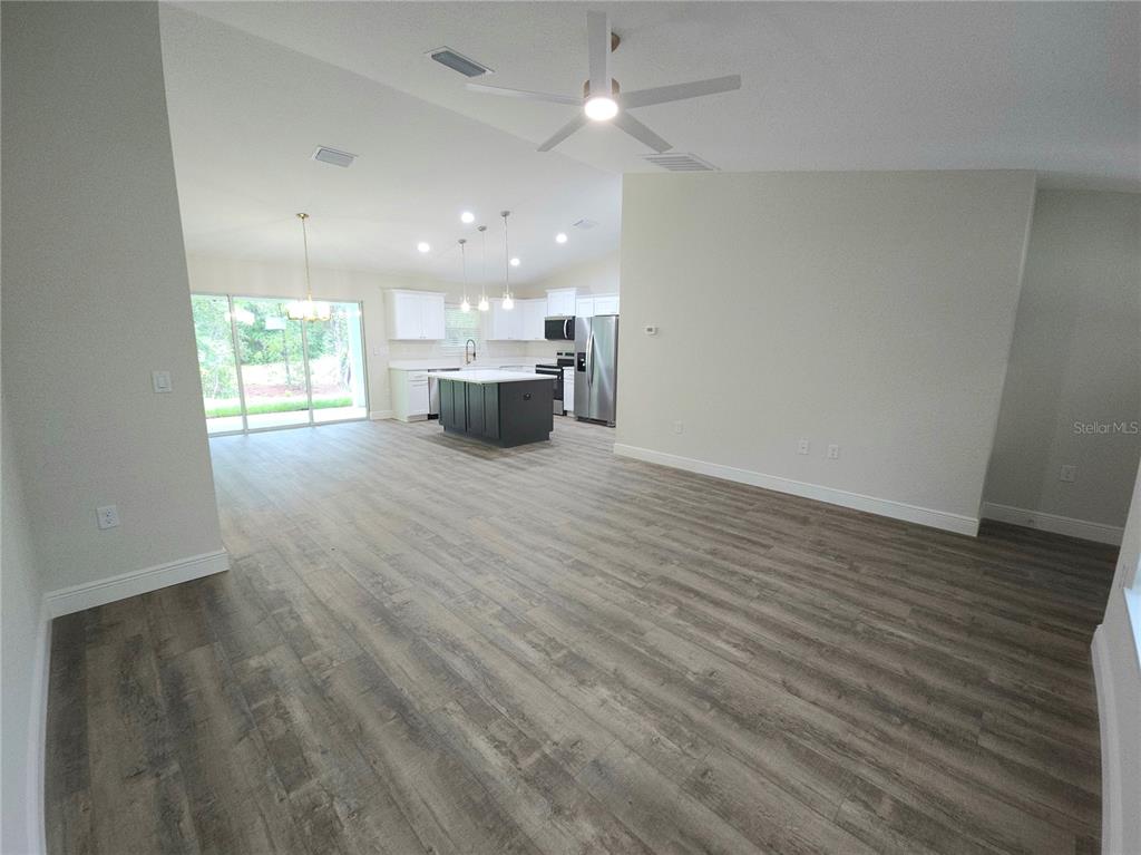 9547 North Sandree Drive Citrus Springs, FL 34434 - Photo 13 of 14 a view of an empty room with wooden floor and a window