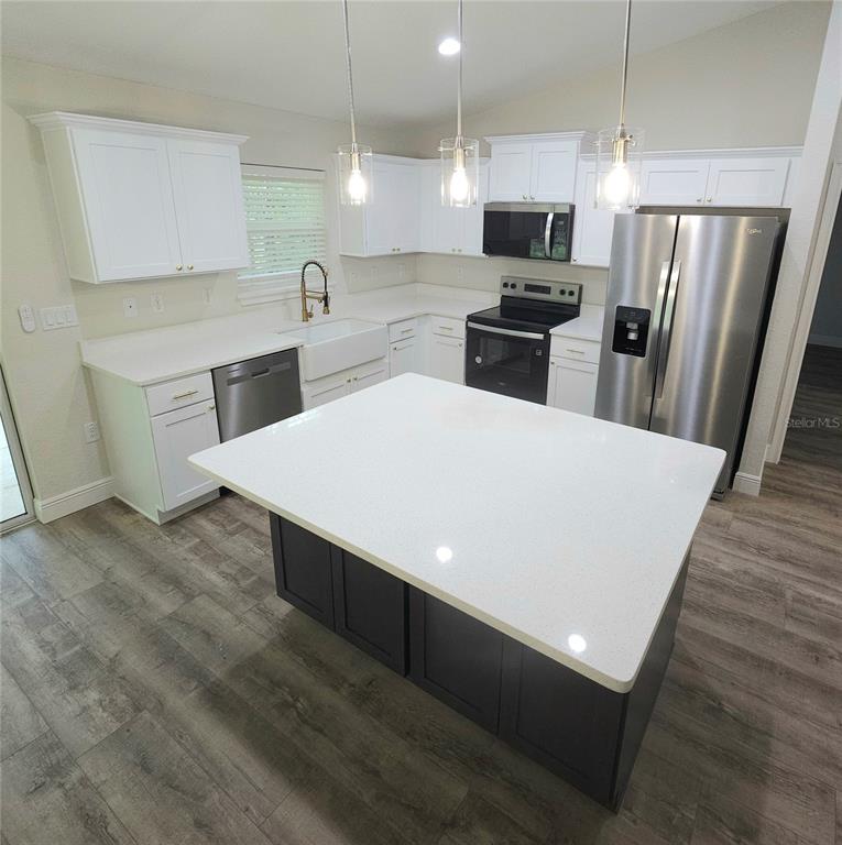 9547 North Sandree Drive Citrus Springs, FL 34434 - Photo 2 of 14 a kitchen with granite countertop a refrigerator a stove top oven a sink and dishwasher