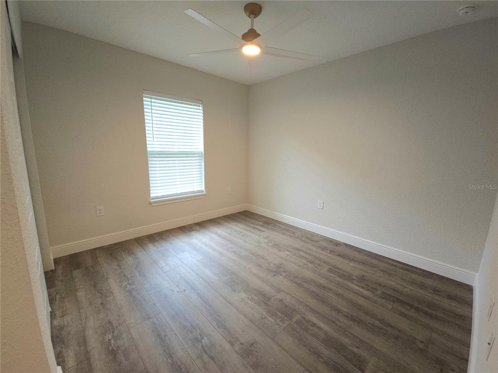 9547 North Sandree Drive Citrus Springs, FL 34434 - Photo 4 of 14 an empty room with wooden floor and windows