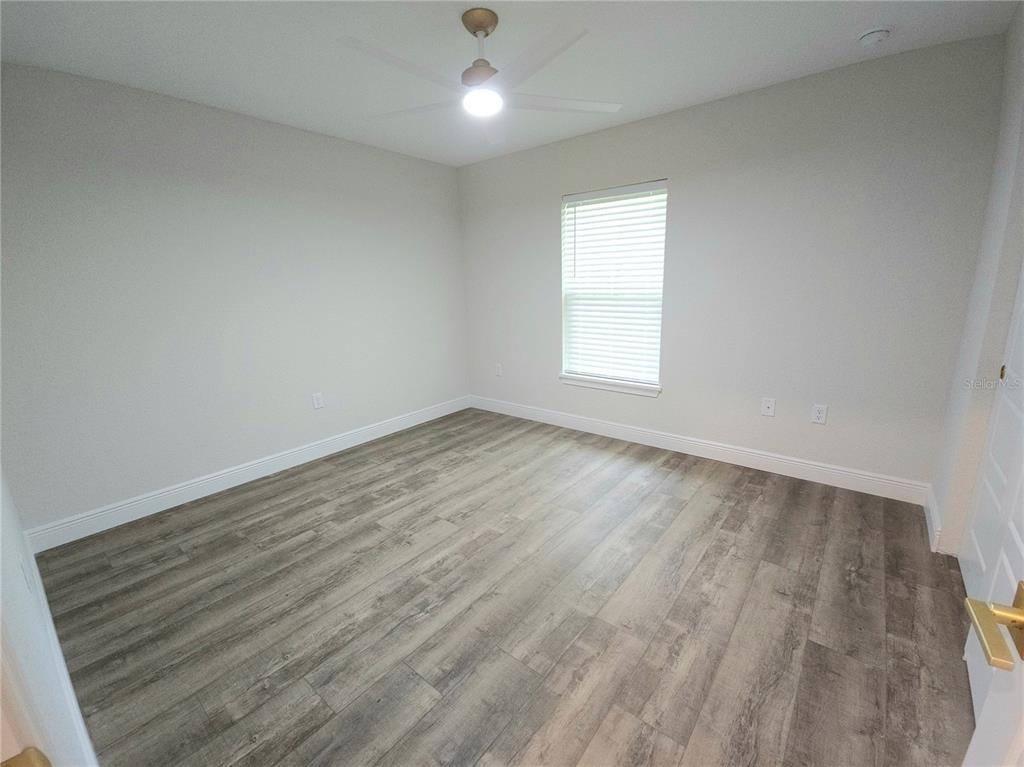 9547 North Sandree Drive Citrus Springs, FL 34434 - Photo 6 of 14 an empty room with wooden floor and windows