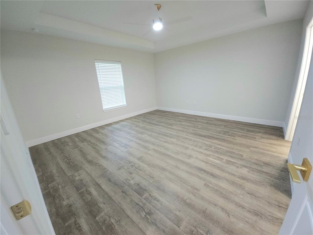 9547 North Sandree Drive Citrus Springs, FL 34434 - Photo 7 of 14 an empty room with wooden floor and windows